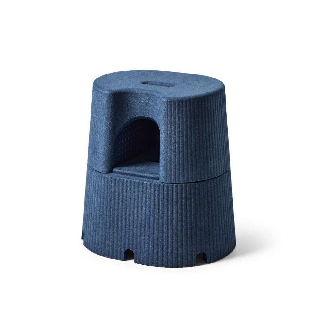 The byACRE DORICA Versatile Step Stool & Seat is a modern blue, two-step stool with a rounded top, ribbed texture, vertical side grooves, a cut-out handle on the upper step, and features a compact cylindrical water-resistant, anti-slip design.